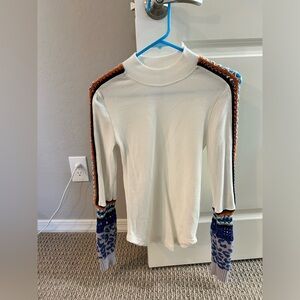 Free People long sleeved top with knit detail on arms and shoulder.